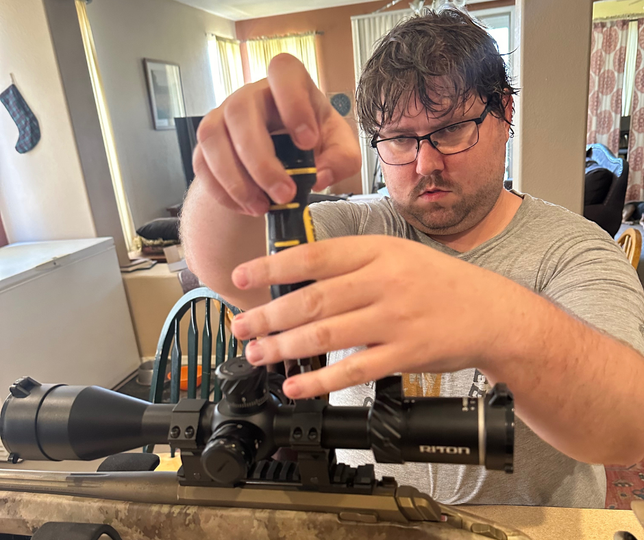 Gray installing a rifle scope
